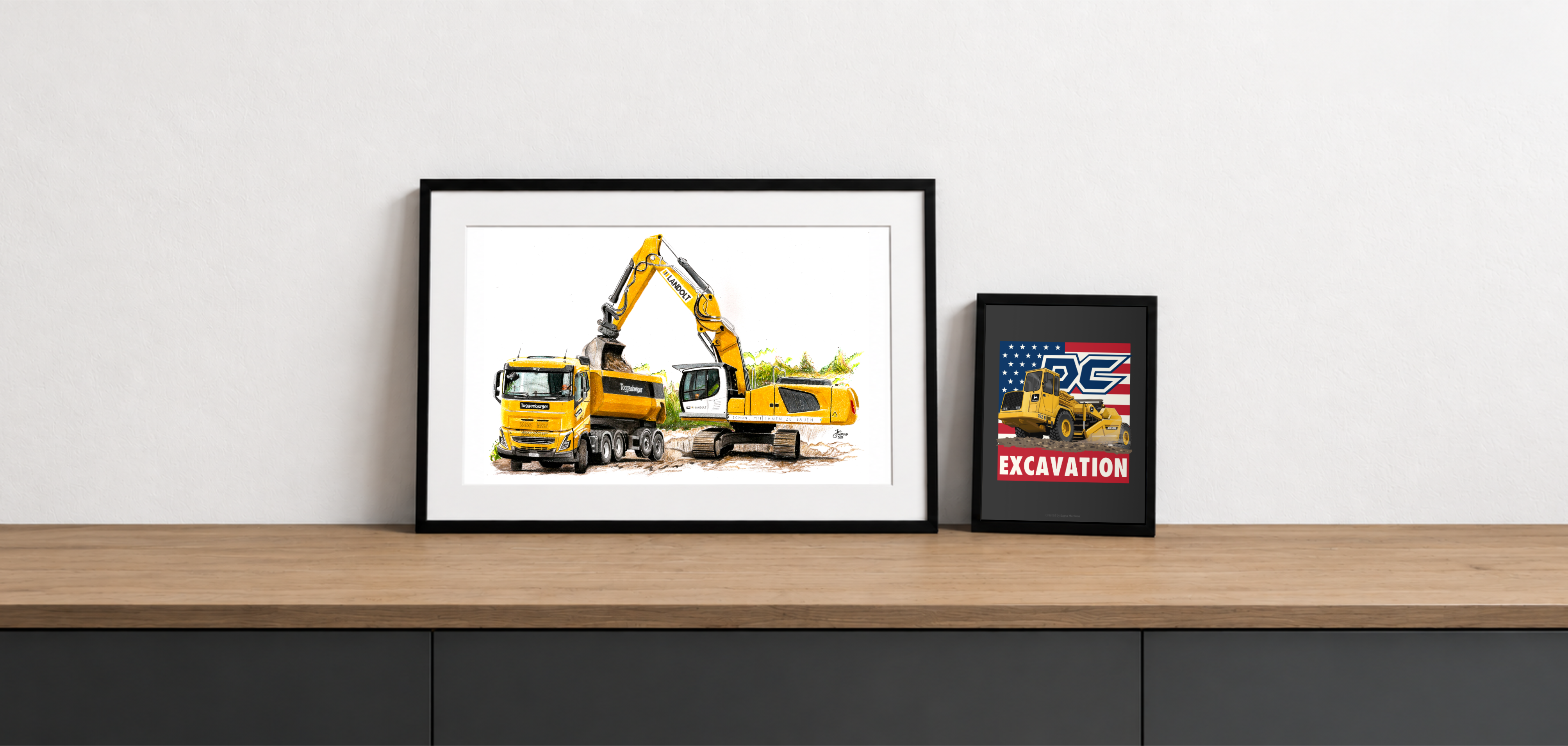 Framed hand-drawn and digital machinery artwork displayed on a console — a truck-and-excavator illustration beside a smaller Develon excavation print